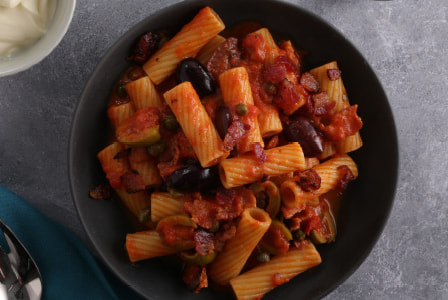 Tomato rigatoni with capers, olives and bacon